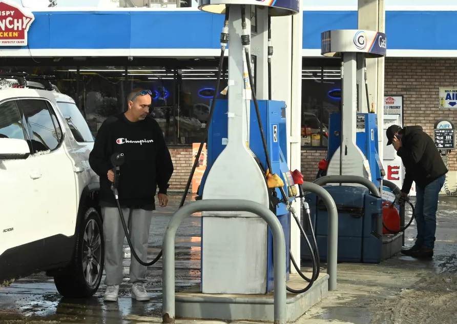 Gas prices fall to four-year lows as millions embark on holiday road trips